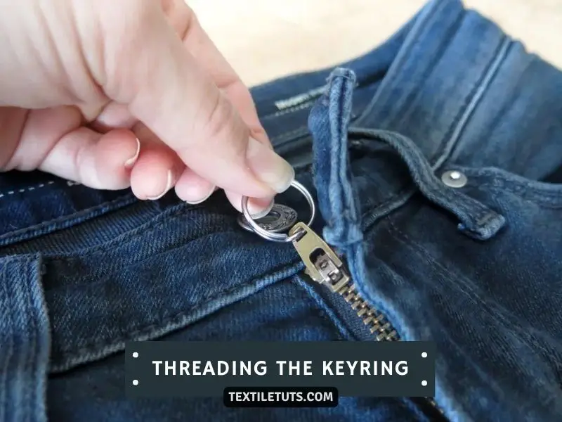 Threading the Keyring Through the Hole at the Top of the Zipper