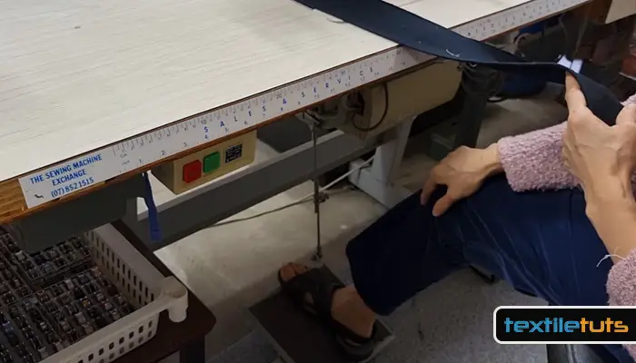 pressing on the sewing machine foot pedal
