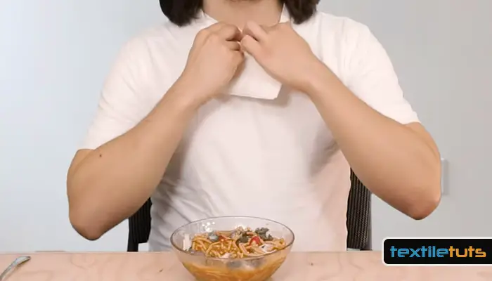 Eating while wearing a white shirt