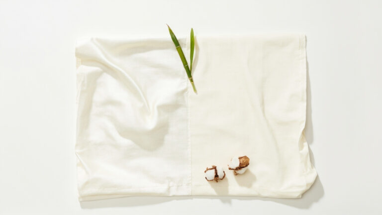 Bamboo fabric and cotton fabric comparison flat-lay showing texture differences for sustainable clothing choice