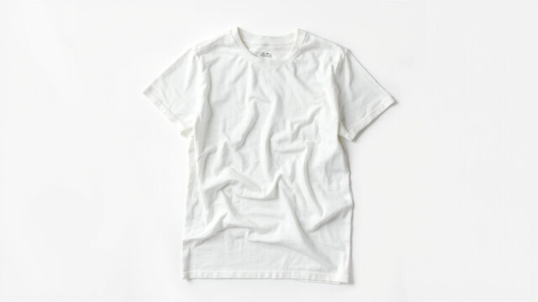 White cotton T-shirt flat-lay with measuring tape showing how to measure before and after washing for shrinkage