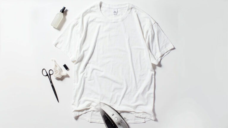 White cotton t-shirt being resized without sewing using heat shrink iron method in a studio setting