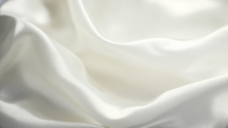 Lustrous white silk fabric showing natural sheen and smooth texture in studio lighting