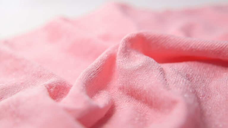 Macro close-up of spandex elastane fabric showing tight knit construction and smooth stretchy texture