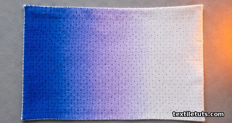 Cotton fabric panel showing a thermochromic color shift from deep blue to pale white across a heat gradient.
