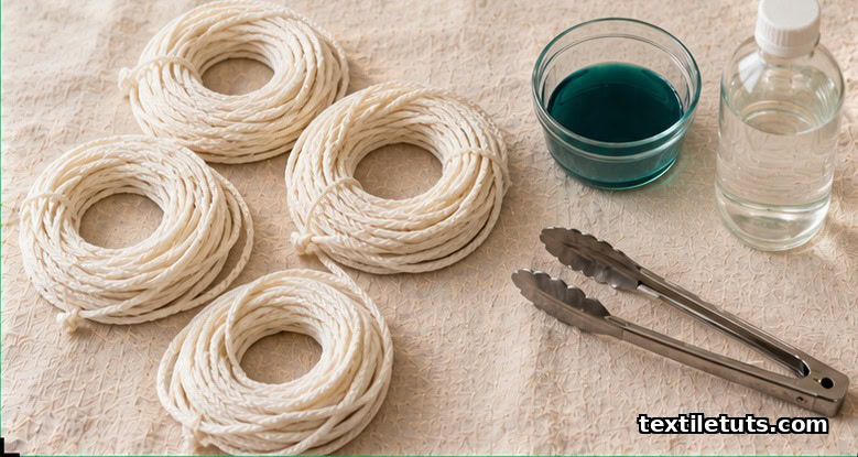 Pre-washed natural nylon rope coils laid out on linen beside a bowl of dissolved acid dye, a vinegar bottle, and stainless tongs.