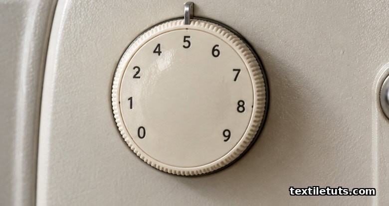 Closeup of a sewing machine top tension dial set to a mid-range value on a0 to 9 scale.