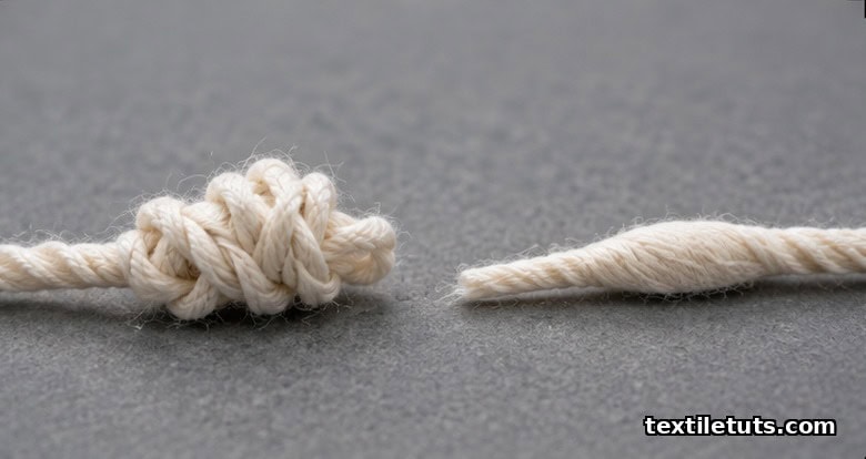Macro comparison of a thick knotted cotton yarn end beside a smooth near-invisible intermingled splice of similar diameter.