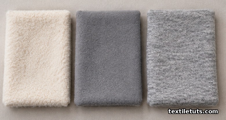 Three folded brushed fleece swatches side by side comparing cotton, polyester, and cotton-polyester blend fabric surfaces and hand.