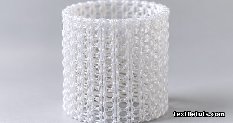 Close-up of a tubular warp-knitted PET sewing cuff fabric used in prosthetic heart valve implants.